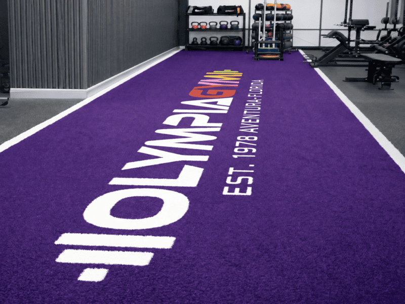 Commercial wheeled resistance sled operating on indoor gym turf